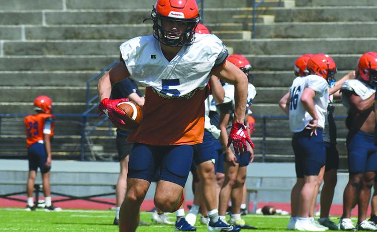 Zeke Whttington turns upfield after securing a pass at practice Wednesday.