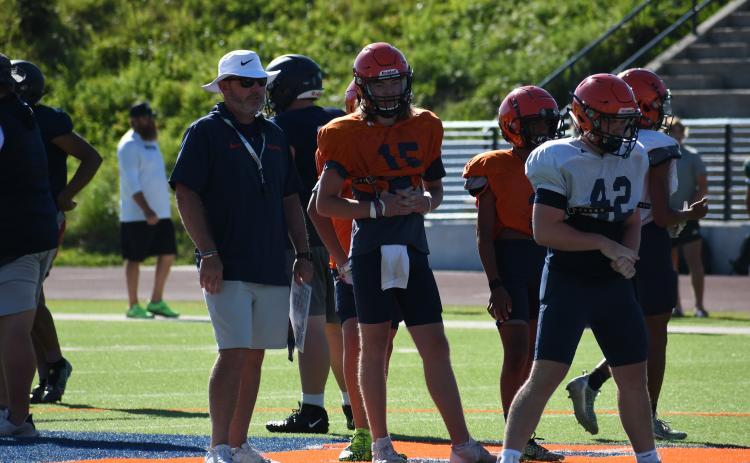 Coach Benji Harrison and quarterback DJ Pass look on as the second team lines up during padded camp. LANG STOREY/Staff