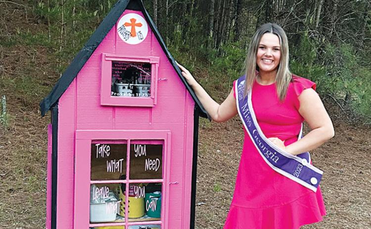 Ansleigh Sherlin stands next to her newly installed blessing box at Little Dreamers Academy in Cornelia.