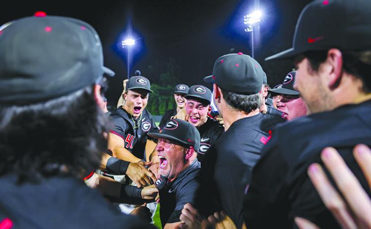 Georgia Head Coach Wes Johnson celebrates with his team after the Bulldogs advanced to the NCAA Super Regionals Sunday night. KARI HODGES/UGAAA