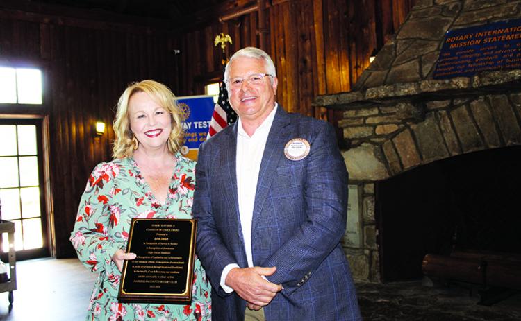 Lisa Smith is given the Robert S. Stubbs Guardian of Ethics Award by Habersham Rotary Club President Bradley Cook. BRIAN WELLMEIER/Special