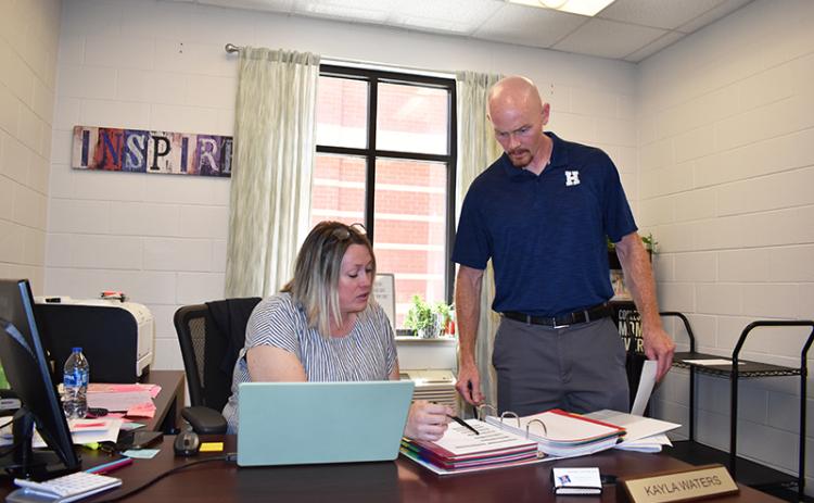 Habersham Central Principal Dr. Adam Bagwell talks with guidance counselor Kayla Waters earlier this week in preparation for the coming school year.