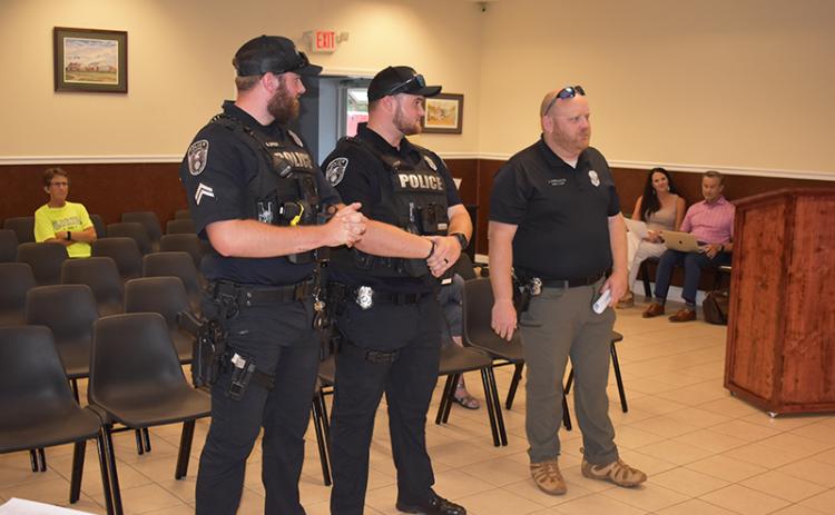 Baldwin  Assistant Police Chief Justin Ferguson (right) and Sgt. Aaron Spivey (left) introduce new officer Logan Ivester to the city council Monday.