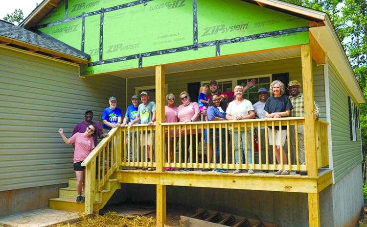 Volunteers celebrate the completion of a recent Habitat for Humanity build in Demorest. SUBMITTED