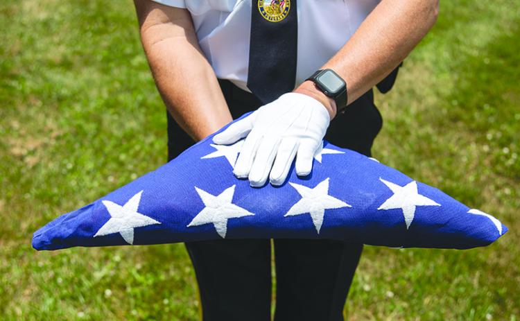 DAV Commander and Honor Guard member Jim Morgan presents the flag wearing white gloves. ZACH TAYLOR/Special