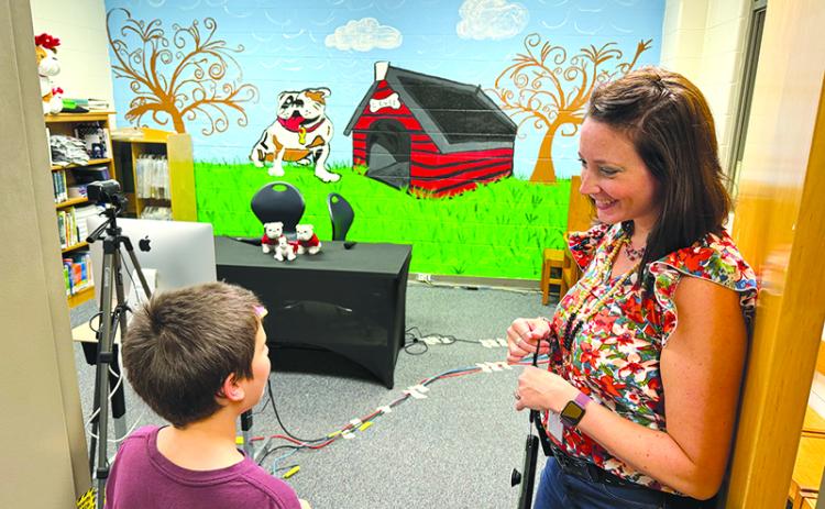Ollie Osborne talks with media specialist Annabelle Wiley about Level Grove Elementary’s Bulldog Broadcast, which is run by fifth graders with staff supervision, at the school’s open house Wednesday. MATTHEW OSBORNE/Staff