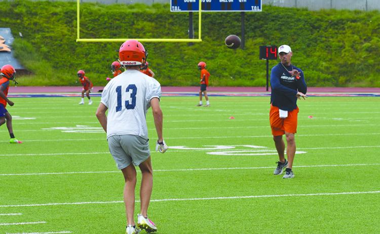 Coach Matt Shirley fires a pass to wide receiver  Drake Roland. LANG STOREY/Staff