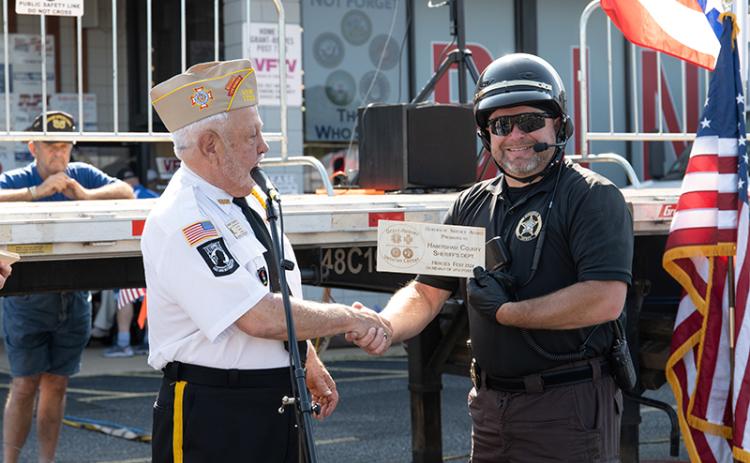 VFW Post 7720 Commander Barry Church hands Aaron Autry a Heroes of Service Award during the opening ceremony of Heroes Fest on Saturday.  ZACH TAYLOR/Staff