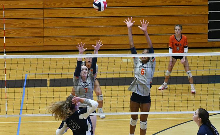 Habersham’s Katelynn LuBuono (left) and McKenzie King go up for a block during a match last week. LANG STOREY/Staff