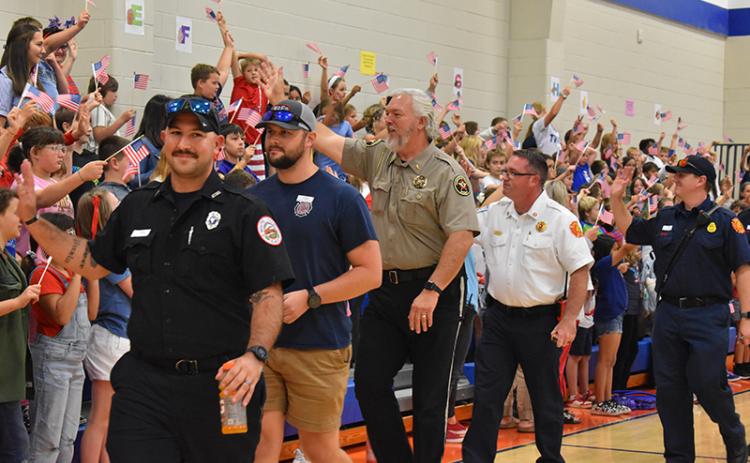 Local first responders wave to students at Fairview. From left, Kenneth Puzio and Will Sexton with White County EMS, Habersham County Sheriff Joey Terrell, Cornelia Fire Marshal Josh Hazle and Cornelia Firefighter Chris Bruce. JULIANNE AKERS/Staff