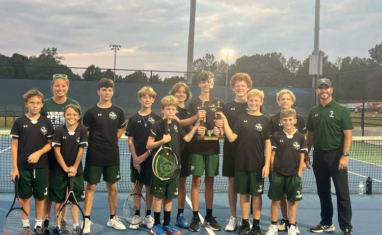 Members of the TFS middle school boys tennis including (from left) Ethan Alderfer, Coach Jennifer Cox, Turner Lander, Maddox English, Isaac Helgeland, Matteus York, Dylan Johnson, Micah Smith, Fenn NeSmith, Jackson Davis, Elijah Pinney, Manager Jase Cox and Coach Anthony Cox celebrate their title run. SUBMITTED