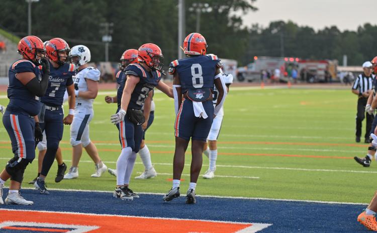 The Raider offense celebrates after Antonio Cantrell (No. 8) finds the endzone in a game earlier this season. TOM ASKEW/Special