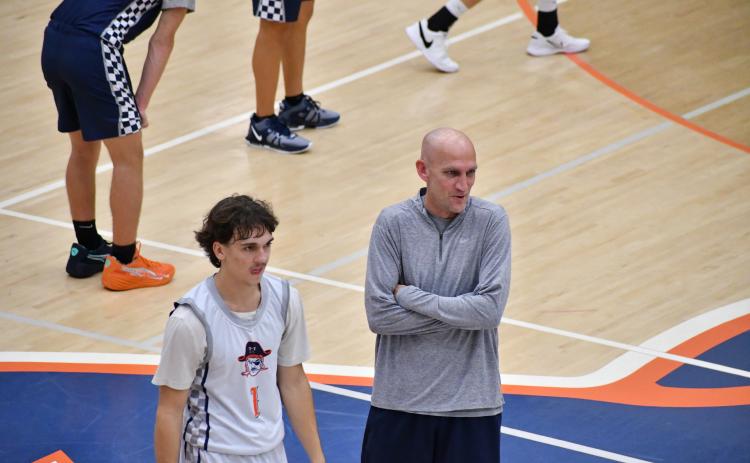 Raider’s guard Caden Garrison (left) and Coach Tommy Yancey crack a joke during practice earlier this week. LANG STOREY/Staff