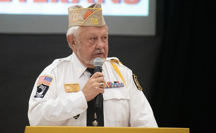 Grant-Reeves VFW Post 7720 Commander Barry Church spoke to veterans and students at Monday morning’s program. JULIANNE AKERS/Staff