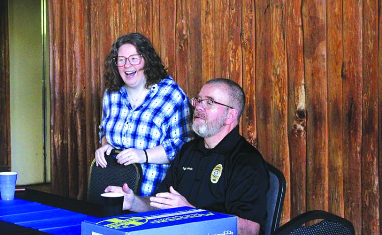 Krystal Risher (left) and Sgt. Deloney Gunnels (right) laugh with a friend during the celebration of Gunnels’ retirement. Risher, who is Gunnels’ daughter, said she is very proud of her father’s accomplishments. HANNAH CAUDELL/Staff