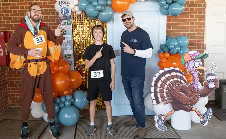 The winner of this year’s Turkey Trot, Jackson Weeks, finished with a time of 20:54, an impressive feat for the youngster battling the hilly route. Weeks stands in between Zach Staggs and Pastor Nathan LaShoto in this photo. ZACH TAYLOR/Staff