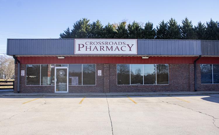 Crossroads Pharmacy sits vacant in its lot in Demorest. In the window, a sign sits that redirects customers to Walgreens for their prescriptions. HANNAH CAUDELL/Staff