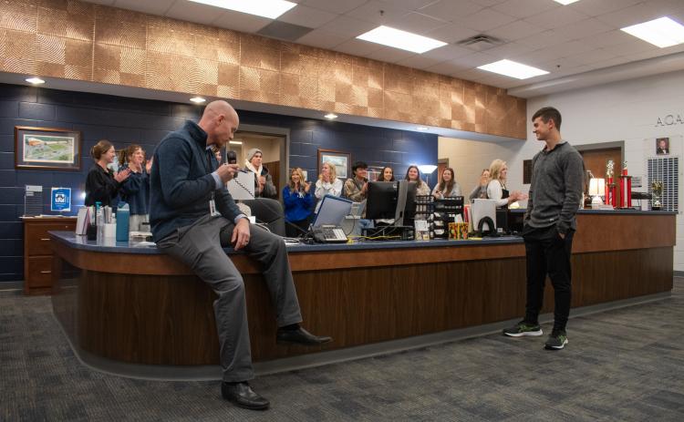 Habersham Central Principal Dr. Adam Bagwell announces Joshua Burris as the 2025 STAR Student recipient for the school, as Burris’ peers clap for him behind the front office desk. HANNAH CAUDELL/Staff