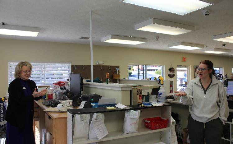 From left, Habersham Drug owner Deborah Gale stands behind the pharmacy counter with her daughter, Hannah. HANNAH CAUDELL/Staff