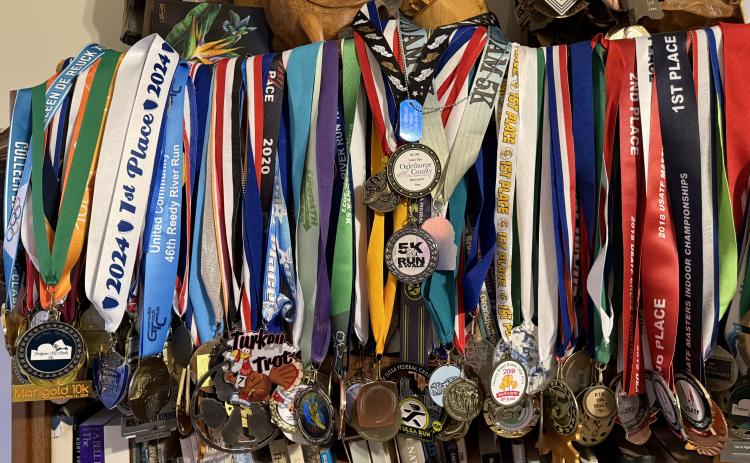 The Turner house in Clarkesville is home to hundreds of race medals acquired through the years. LANG STOREY/Staff