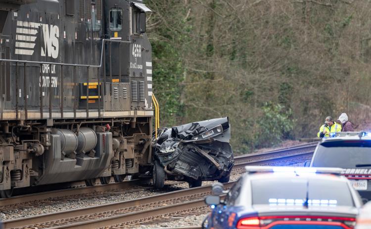 A train struck a Lincoln sedan at the railroad crossing on Main Street in Cornelia. No injuries were reported, with the sole occupant of the vehicle refusing medical care from Habersham’s Med 12. The crushed car is seen approximately 200 feet from the impact location. ZACH TAYLOR/Staff