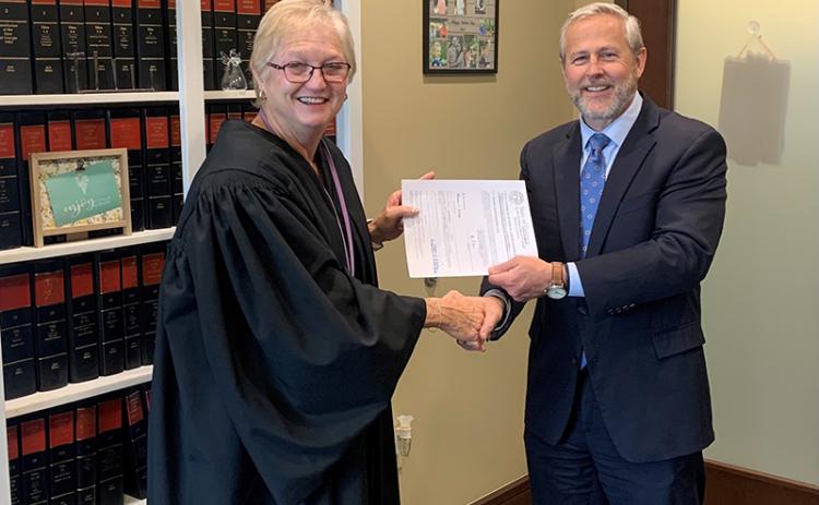 Probate Judge Pamela Wooley, left, shakes hands with Superior Court Judge Chan Caudell in a swearing-in ceremony in December. HABERSHAM COUNTY/Submitted