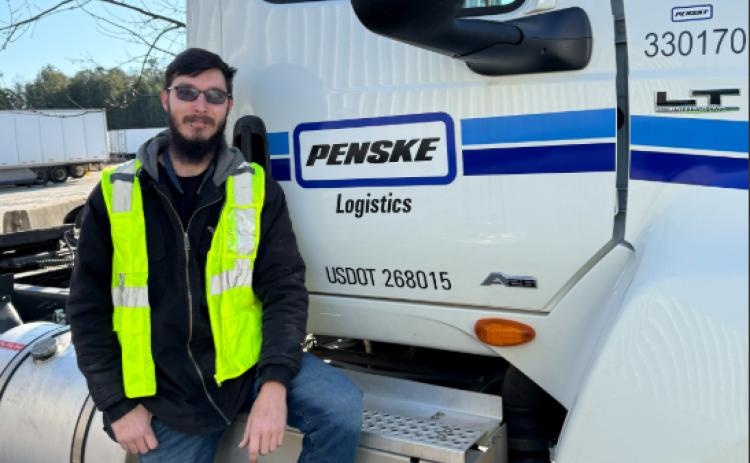Penske Logistics Truck Driver William Mitchell of Alto is pictured with the Penske truck he drives. Mitchell was responsible for saving the life of a pickup truck driver after witnessing a crash between the pickup truck and a fuel tanker. SUBMITTED