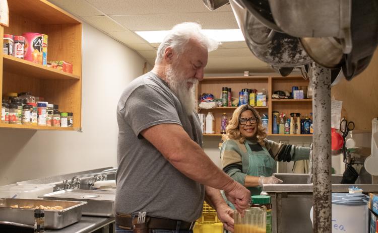 Married duo Bill and LeeAnn Waller prepare food and drinks on an early Saturday morning before guests arrive at the Cornelia “Lord’s Help” Soup Kitchen. HANNAH CAUDELL/Staff