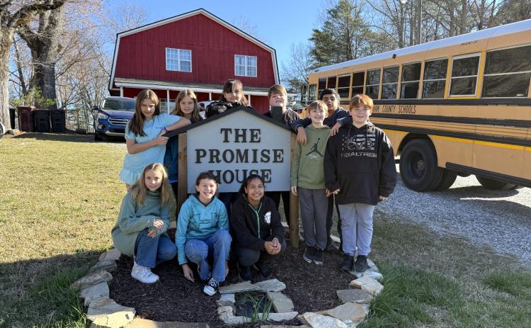 Students of the Hazel Grove Elementary Teach One to Lead One program stand with the Family Promise sign outside of the Family Promise of White and Habersham facility, a nonprofit dedicated to remedying homelessness in the North Georgia region. Pictured from left to right are (front) Violet Ramey, Brin Forrester, Aiyana Sutton, (back) Chloe Baird, Willow Ingebrigsten, Riley Gallahan, Konnor Tucker, Mason Harris, Matheo Garcia Vega and Ayden Meiburg. SUBMITTED