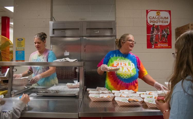Ann Lewallen (right) works in the Cornelia Elementary School kitchen service line to serve the children coming through for breakfast on Thursday morning. HANNAH CAUDELL/Staff