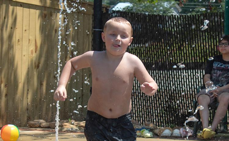 Nathan Dickerson plays at the Cornelia Splash Pad on a hot Tuesday morning. Taking the kids to the pool or the splash pad may be one way to beat the extreme heat this week in Habersham County. (HANNAH CAUDELL/Staff)