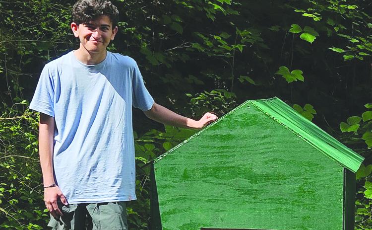 David Quintal poses with one the dog houses he built with a team of volunteers for his Eagle service project. SUBMITTED