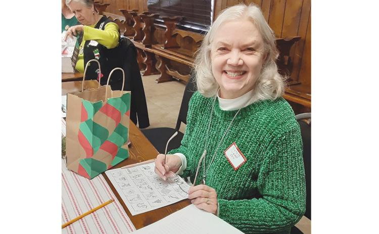 Leslie Rohrabacher enjoys serving in the Tomochichi Chapter of the Daughters of the American Revolution. Above, she works with the chapter to stuff gift bags for veterans last December. (Submitted)