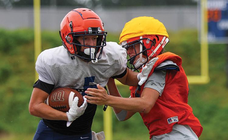 Habersham Central Maverick Chitwood and defender Preston Tatum collide during football practice at Raider Stadium on Wednesday, July 30. (Landen Todd/Staff)