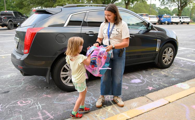 Clarkesville Elementary School Counselor Anna Neese helps kids out of their parents’ cars on the first day of school. (Zach Taylor/Staff)