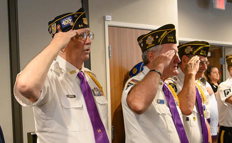 Honor Guard members Ed Hendricks, Rick Chaffin and Gary Cantwell salute as Danny Stephens plays the bugle. (Zach Taylor/Staff)
