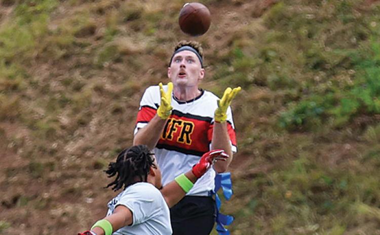 First responder Kyle Weatherly receives the ball for a touchdown during the Battle of the Heroes on Saturday, Aug. 2 at Raider Stadium. Hall County won 44-6. (Landen Todd/Staff)