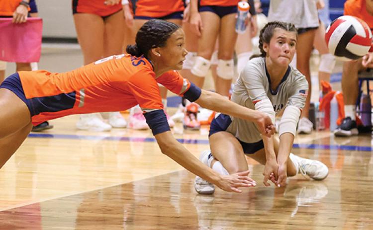 Habersham Central senior Kenzie King (12) and sophomore Sydney Patterson (2) go after the ball during a volleyball match at Banks County High School on Tuesday, Aug. 19. The Lady Raiders beat the Red Raiders (25-14, 20-25, 15-11) and beat the Leopards (27-25, 25-22). (Landon Todd/Staff)