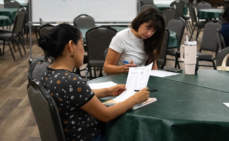 Volunteer April Matson (right) prepares to help a returning student for the Volunteers for Literacy Adult English Language Acquisition program. (Hannah Caudell/Staff)