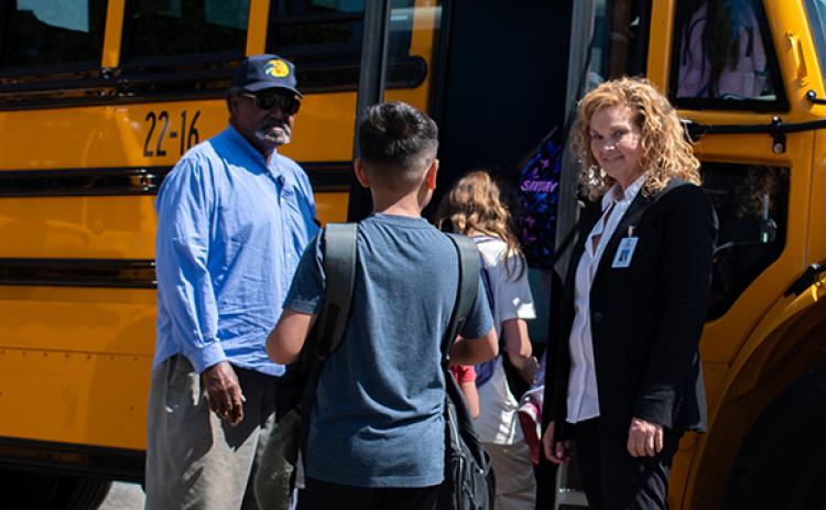 Habersham County School Bus Driver Verner Kesler (left) greets children who board the bus after a Monday school day at Cornelia Elementary. Transportation Director Stephanie Walker (left) is also there to greet students. (Hannah Caudell/Staff)