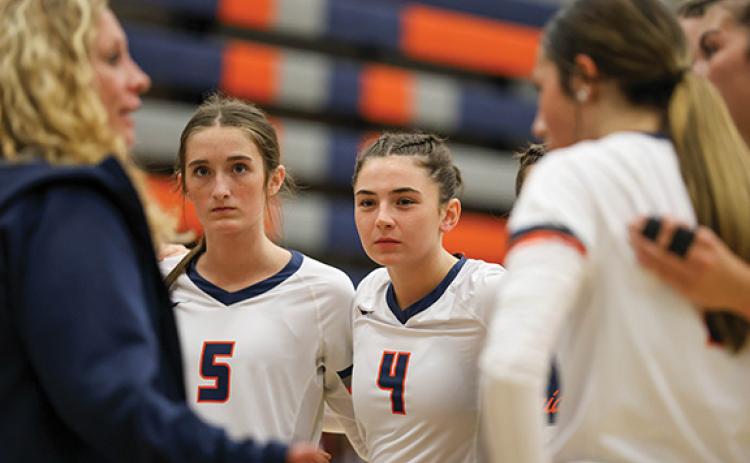 The Lady Raiders huddle up during a match between Jackson County and Habersham Central at Raider Gymnasium on Tuesday, Sept. 16. (Landen Todd/Staff)