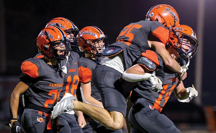 Habersham Central senior linebacker Sawyer Burgess (14) celebrates with his teammates after his interception during a game between Winder-Barrow and Habersham Central at Raider Stadium on Friday, Sept. 26. (Landen Todd/Staff)
