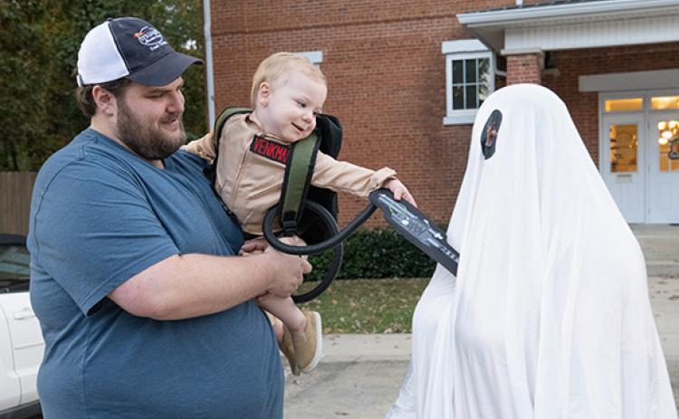 Dalton Pitts (center) worked on his ghostbusting skills with his parents, Victoria and Alex Pitts, during Mt. Airy’s Trunk or Treat event last year. (Zach Taylor/Staff)