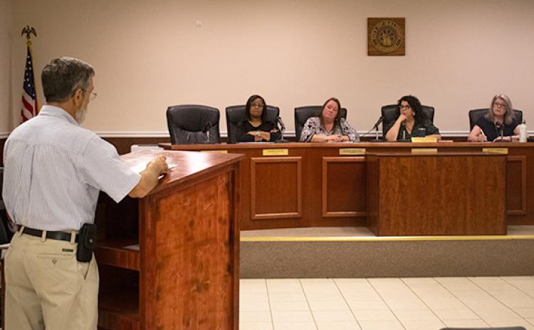 John Smith, a Baldwin resident on the Banks County side of the city, spoke before four council members to oppose the millage rate during one of Baldwin’s public hearings on Thursday. He believes something has gone awry in Baldwin after the revenue from millage rate increases have more than doubled since 2022. (Hannah Caudell/Staff)