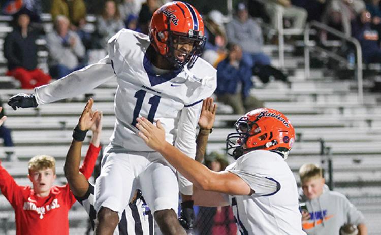 Habersham Central junior wide receiver Jay Feltus (11) celebrates with senior lineman Austin Williams (51) during a football game between Habersham Central and Apalachee at Apalachee Wildcats Football Stadium on Friday, Oct. 24. Feltus caught three touchdown passes in the second quarter.  (Landen Todd/Staff)