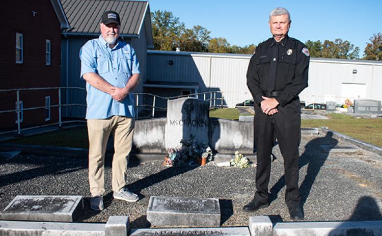 Chad White (left), a retired captain with the Hall County Sheriff’s Office and a police historian, stands with Clarkesville Police Chief Danny Clouatre at the grave of Charles Arthur Vick, a Habersham County Sheriff’s Office and Clarkesville Police Department officer who lost his life in the line of duty in 1962. (Hannah Caudell/Staff)