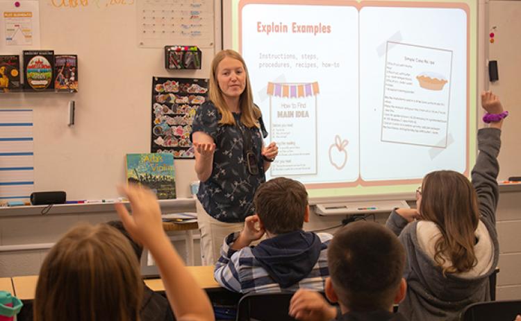 Hazel Grove Fifth Grade Teacher Stephanie Morris teaches her students about different writing genres during a class session on Tuesday morning. Morris is one of many staff members at Hazel Grove that Principal Stefanie Eaton commended on Monday night after Superintendent Patrick Franklin announced Hazel Grove had earned Title I Reward School status. (Hannah Caudell/Staff)