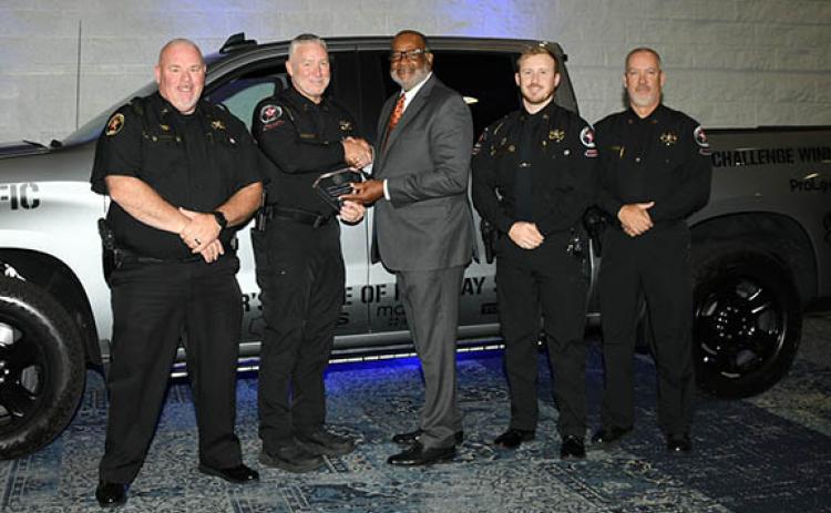 The Habersham County Sheriff’s Office team, including Sheriff Robin Krockum (far left) smile as Allen Poole, the director of the Governor’s Office of Highway Safety (middle), presents them with the sheriff’s office’s third place award in Category Four in the Governor’s Challenge Awards. The sheriff’s office also earned HEAT Team of the Year for the fourth time. (Submitted)
