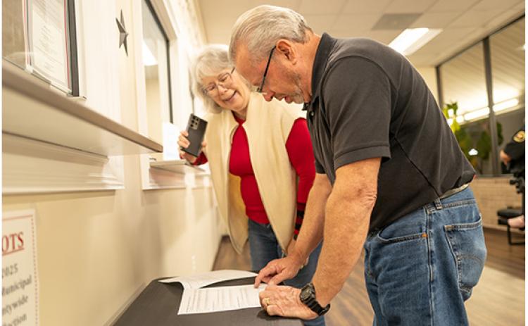 Demorest council candidates Patti Davis and Jim Welborn take a look at precinct results at the Habersham County Elections and Voter Registration Office Tuesday night.  (Zach Taylor/Staff)