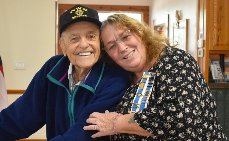 Tomochichi Chapter Regent Lynn McCollum (right) hugs World War II veteran Andy Negra during a special meeting honoring veterans. (Samantha Sinclair/Staff)